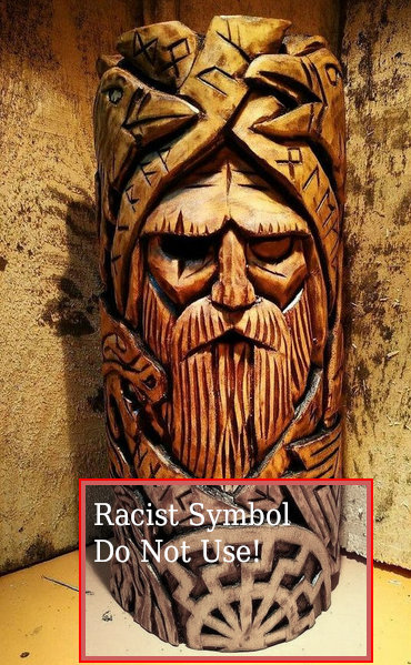 A wooden statue of Odin with a black sun symbol incorporated into it